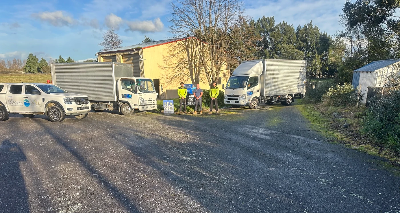 Blair Smith and the NZ Spas Wairarapa team with their vehicles outside the Masterton showroom