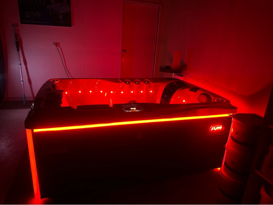 Illuminated spa pool with blue and red lighting in the Masterton showroom