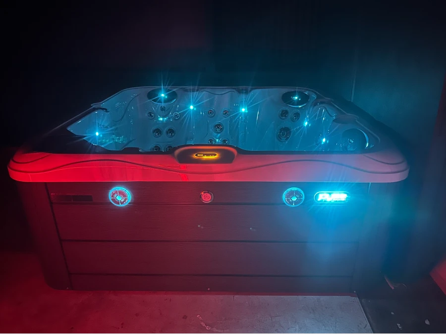 Spa pool illuminated with red exterior lighting